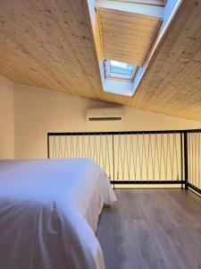a bedroom with a bed and a skylight at VUT La Casa de la Sierra in El Barraco
