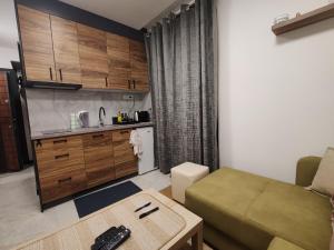 a small living room with a couch and a table at Bella Winterhouse Kopaonik in Kopaonik