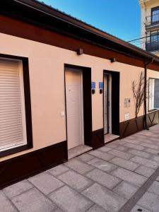 a row of doors on the side of a building at VUT La Casa de la Sierra in El Barraco +15 photos
