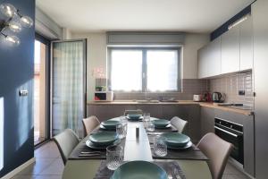 a kitchen with a table with green dishes on it at CITY CENTER - Modern flat with FREE PARKING and WIFI - Apt A in Bergamo