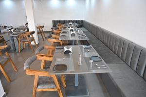 a row of tables and chairs in a restaurant at K7 Hotel & Restaurant in Rānchī