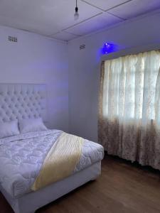 Ένα ή περισσότερα κρεβάτια σε δωμάτιο στο Elgin Guest