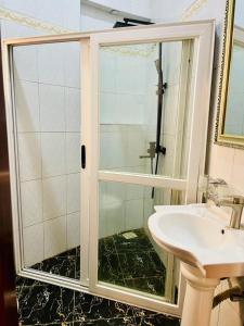 a bathroom with a shower and a sink at 6 Engo Cottage - Benanda Forest Resort in Masaka +35 photos