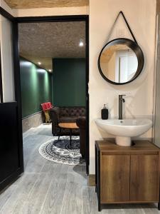 ein Badezimmer mit Waschbecken und Spiegel in der Unterkunft Maison bien-être avec bain nordique et sauna in Ferrières