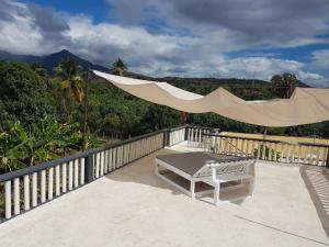 a patio with a hammock and a bench on a balcony at Finca im Grünen, sehr ruhige Lage, Terrasse mit Pool in Baní