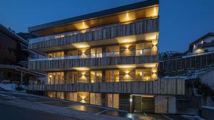 an apartment building with lights on in the snow at Alpine Myth in Sankt Anton am Arlberg