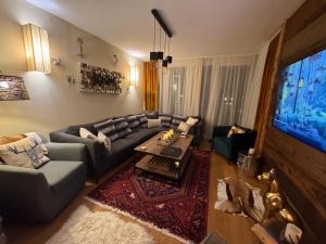 a living room with a couch and a table at Alpine Myth in Sankt Anton am Arlberg