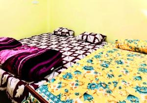 two beds sitting next to each other in a bedroom at Bk 2 Y in Prayagraj