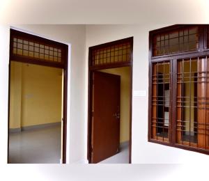 two doors and windows on a white building at Bk 2 Y in Prayagraj +1 photo