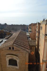 a building with a tile roof in a city at kis inn affitacamere guesthouse in Rome