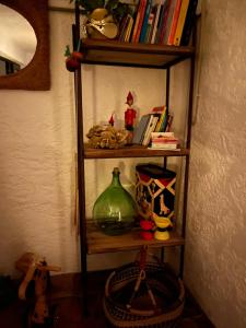 a book shelf with toys and books on it at Rez de jardin au calme dans le parc des calanques in La Ciotat