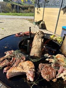 a grill with meat and vegetables on a table at L'Hôtentique in Turriers