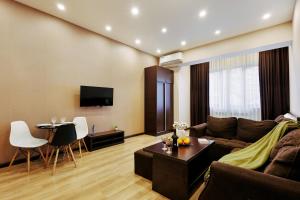 a living room with a couch and a table at Residence North Avenue, Teryan 8. 14 2 in Yerevan