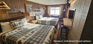 a small room with two beds in a train at Lakeshore Motel Ice Lake in Iron River