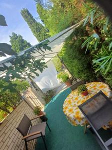 a patio with an umbrella and a table and chairs at Studio San Simon close to beach in Izola