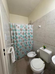 ein Badezimmer mit Toilette und Duschvorhang in der Unterkunft Departamento moderno y luminoso in Barrio Rivadavia