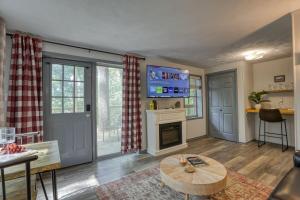 a living room with a table and a fireplace at Moose Suite 1King Bed 1Queen Sofa bed + Hot Tub in Gatlinburg