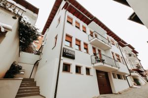 a building with a sign on the side of it at Livinn Apartments-Twin Room with Shared Bathroom in Prizren