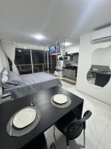 a bedroom with a bed and a table and chairs at Rn Studio in Maceió