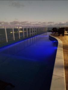 a swimming pool on the roof of a building at Rn Studio in Maceió