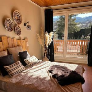 a bedroom with a large bed and a large window at L'Hôtentique in Turriers +37 photos