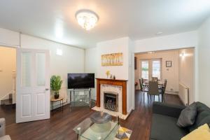 a living room with a couch and a fireplace at Stylish 4 Bed Henbury Home with Free Parking in Bristol