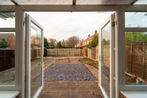 an open door to a yard with a fire hydrant at Stylish 4 Bed Henbury Home with Free Parking in Bristol