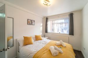 a bedroom with a large bed with towels on it at Stylish 4 Bed Henbury Home with Free Parking in Bristol