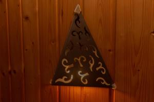 a black party hat hanging on a wooden wall at Guet House Vila tejo in Vila Franca de Xira