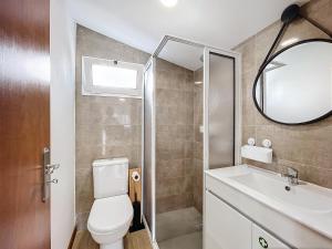 a bathroom with a toilet and a sink and a mirror at Dinos Sea View in Machico +6 photos