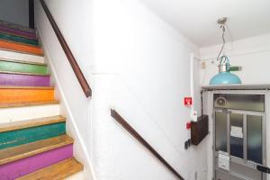 a hallway with colorful stairs in a house at Guet House Vila tejo in Vila Franca de Xira