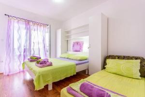 sypialnia z dwoma łóżkami i ręcznikami na nich w obiekcie Apartments Nada w mieście Banjol