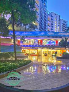 a building with lights on in a city at night at I-City Liberty 1 Room FreePark BASRI PROPERTI in Shah Alam