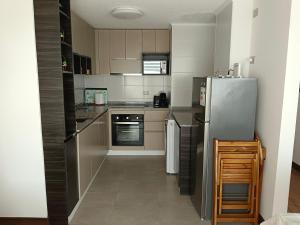 a kitchen with a stainless steel refrigerator and appliances at Acogedor Dpto en LLanquihue se admite TAR-CRED -TAR-DEB in Llanquihue