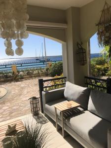 a living room with a couch and a view of the ocean at Luxury Oceanfront Elegancia in Kralendijk