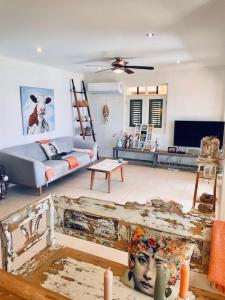 a living room with a couch and a table at Luxury Oceanfront Elegancia in Kralendijk