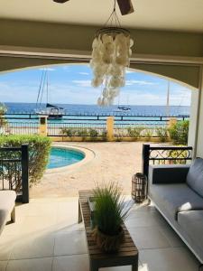 a living room with a couch and a view of the ocean at Luxury Oceanfront Elegancia in Kralendijk
