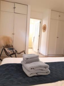 a pile of towels sitting on top of a bed at Luxury Oceanfront Elegancia in Kralendijk