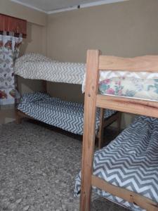 En eller flere senge i et værelse på Complejo Extremo 4