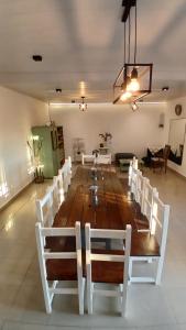 a large wooden table and chairs in a room at Quinta Las Flores by Ginkgo Hostel in La Plata