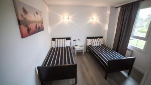 Posteľ alebo postele v izbe v ubytovaní H.A.N.D Surf Hostel