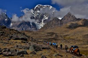 a group of people walking on a mountain trail at Casa Cóndor Ausangate in Tinke