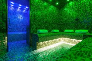 a room with a tub with green and blue lights at Hotel Artemide in Rome