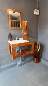 a bathroom with a sink and a mirror at Quinta Las Flores by Ginkgo Hostel in La Plata