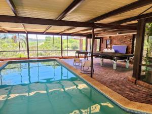 a swimming pool in a house with a ping pong table at Vineyard Retreat in the Heart of McLaren Vale in McLaren Vale