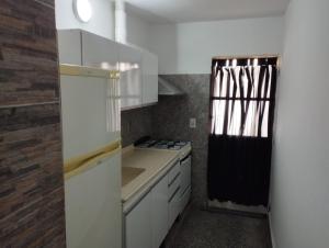 a kitchen with white cabinets and a stove top oven at La Guido 3 sin operar in Viedma