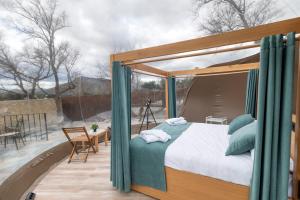 a bedroom with a canopy bed on a patio at Hotel Zielo Las Beatas in Santa Maria +40 photos
