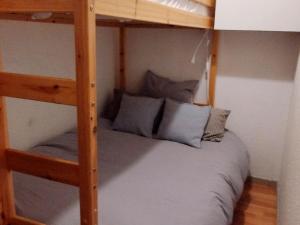 Les AdretsCharmant 2 Pièces Cabine au Pied des Pistes - 7 Couchages - FR-1-771-60的一间卧室配有带蓝色枕头的双层床