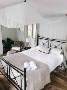 a bedroom with a large white bed with two pillows at Earthly Retreat - Private Noosa Hinterland Getaway in Doonan