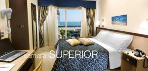 Ένα ή περισσότερα κρεβάτια σε δωμάτιο στο Hotel Ambasciatori